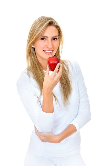 Beautiful woman in white with a red apple isolated