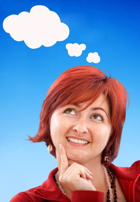 Thougthful woman with red hair isolated over blue