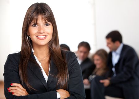 Beautiful business woman portrait with a group behind her