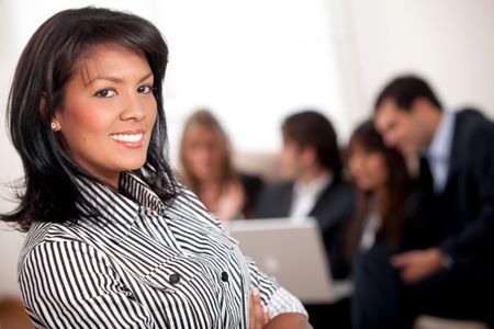 Business woman smiling and a group at the background