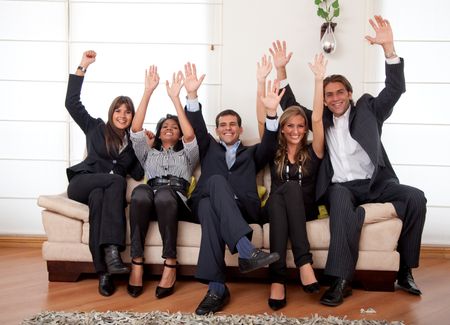 Excited business group on a couch at an office