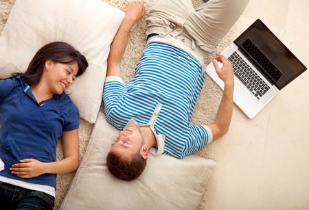 Loving couple relaxing lied down on the floor