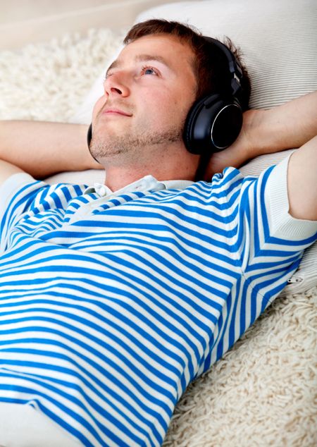 Relaxed man with headphones listening to music