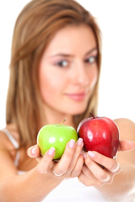 Beautiful woman holding two apples isolated over white