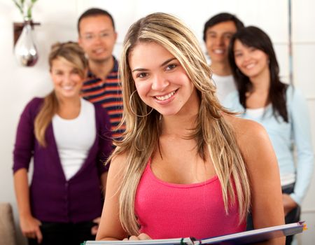 Happy group of students led by a woman indoors