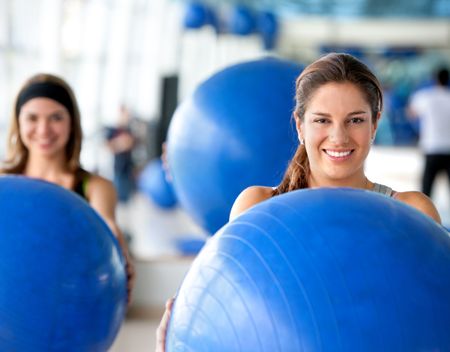 women portrait at the gym with pilates ball