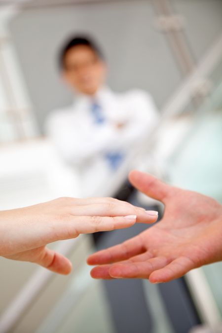 Business people sealing the deal handshaking in an office