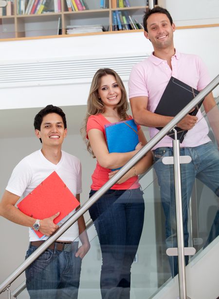 Happy group of students with folders smiling