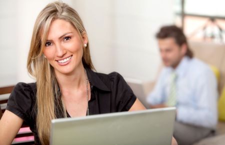 Happy business woman with a laptop smiling