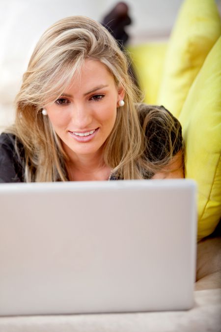 Business woman working on a laptop smiling