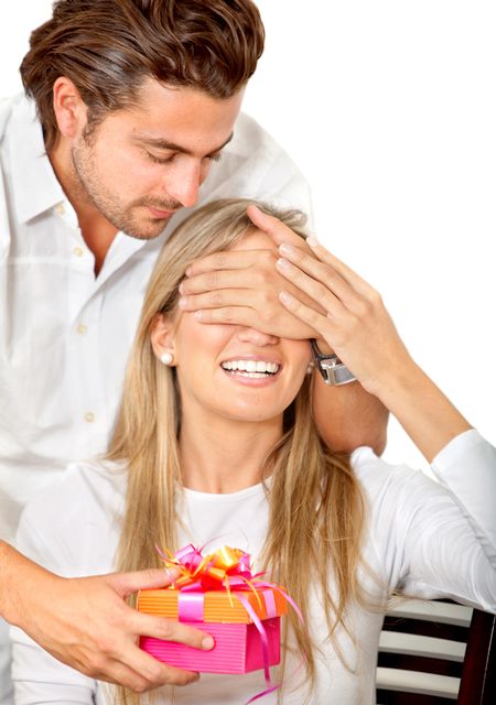 Man giving a present to his girlfriend isolated over white