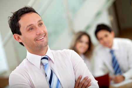 Young man leading a business team in an office