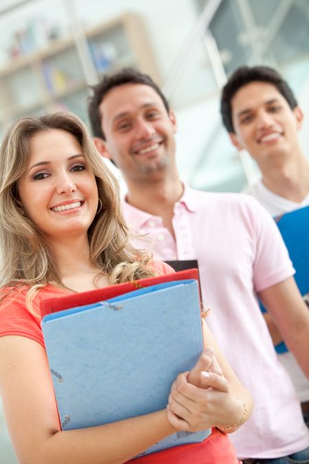 Happy group of students in a row smiling