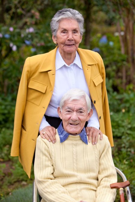Portrait of an elderly couple smiling outdoors