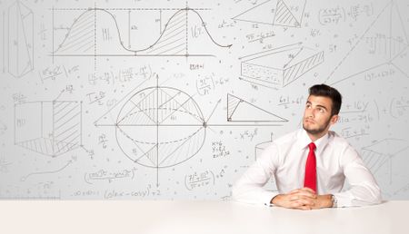 Business man sitting at white table with hand drawn calculations background