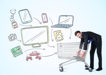 Businessman pushing a shopping cart drawn media devices coming out of it 