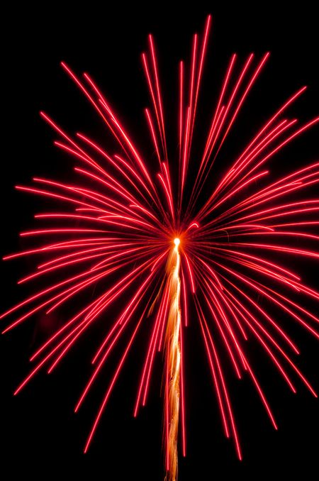 Vivid reddish orange burst of fireworks