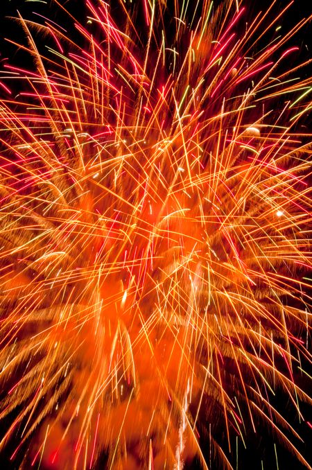 Chaos of sparks flying furiously in all directions during fireworks finale