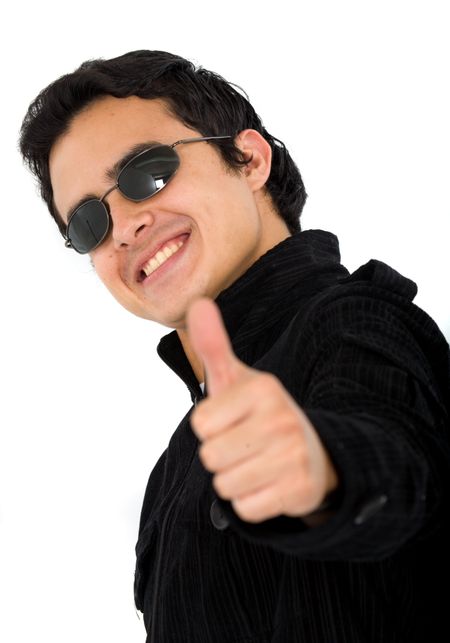 positive and happy young man with his thumb up and wearing sunglasses