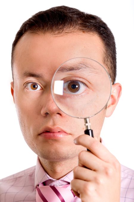 man holding a magnifying glass next to his eye