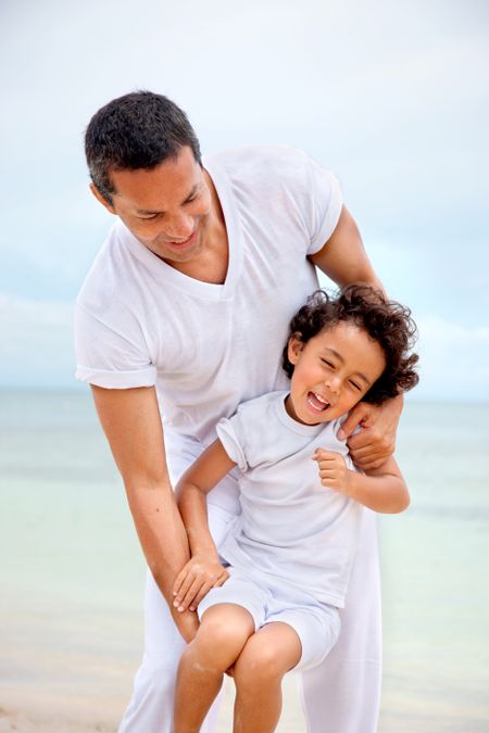 Man and son having fun at the beach