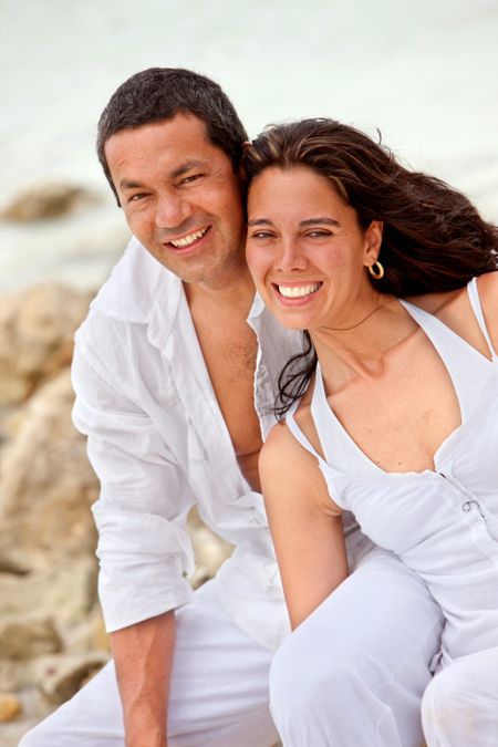 Beautiful loving couple at the beach smiling