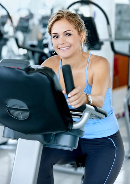 Beautiful woman portrait at the gym cycling