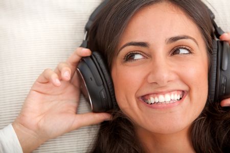 Beautiful woman portrait with earphones and smiling