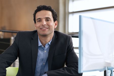 Portrait of a confident businessman at work in his glass office