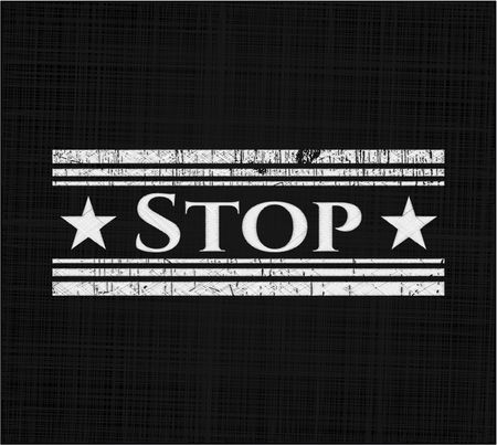 Stop chalkboard emblem written on a blackboard