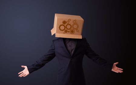 Young man standing and gesturing with a cardboard box on his head with spur wheels