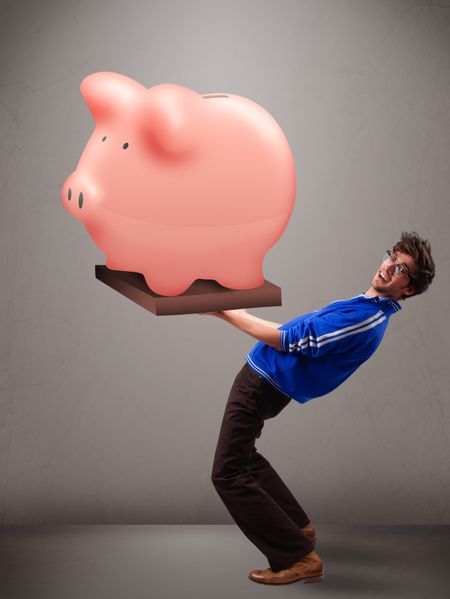 Handsome young man holding a huge savings piggy bank