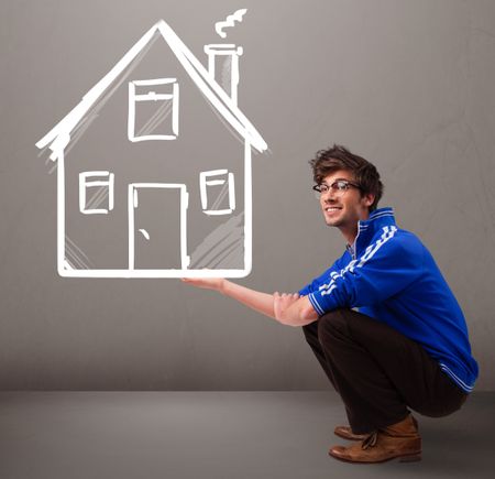Attractive young boy holding a huge drawn house