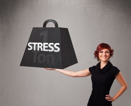 Attractive young woman holding one ton of stress weight