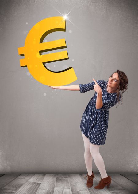 Beautiful young girl holding a big 3d gold euro sign
