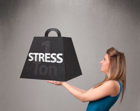 Attractive young woman holding one ton of stress weight