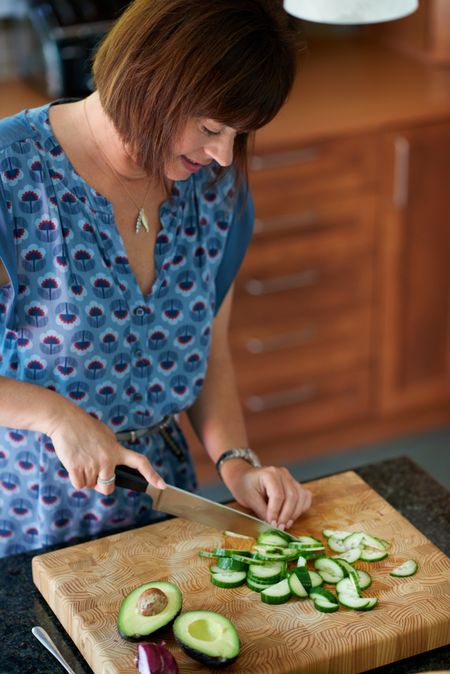 Mature woman chopping vegetables