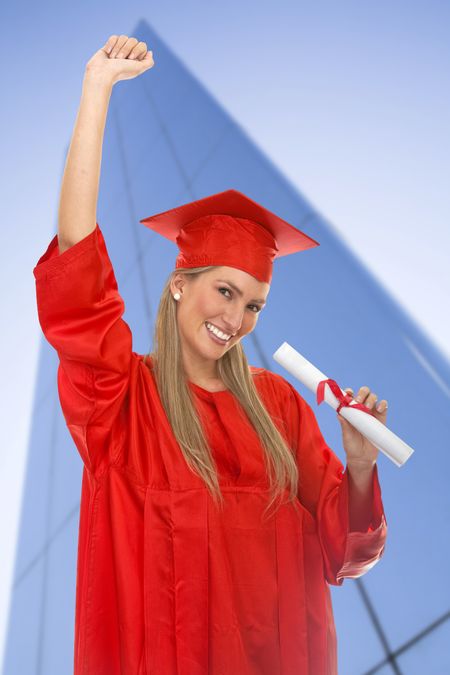 Happy female graduate in red gown smiling