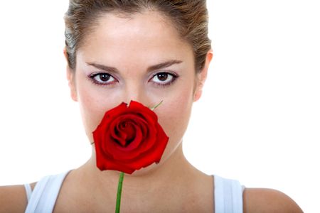 Beautiful woman covering her face with a rose isolated