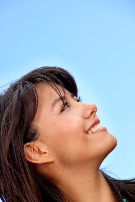 Woman portrait outdoors with the sky as the background
