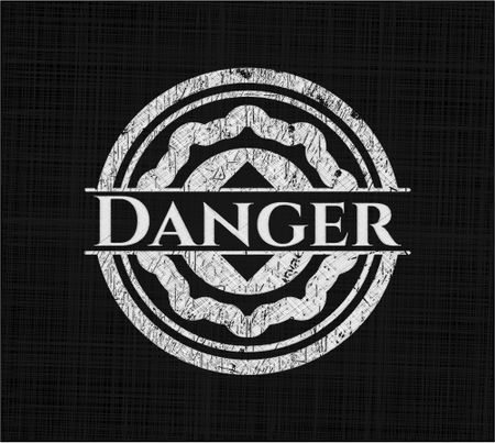 Danger chalkboard emblem written on a blackboard