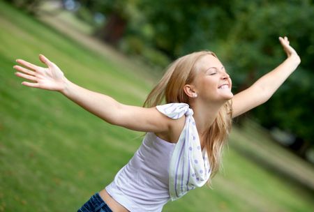 Freedom woman with opened arms outdoors smiling