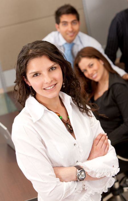 Business woman portrait and her team behind