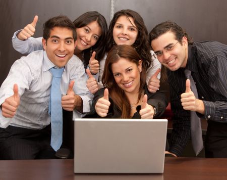 Business group with thumbs up in an office