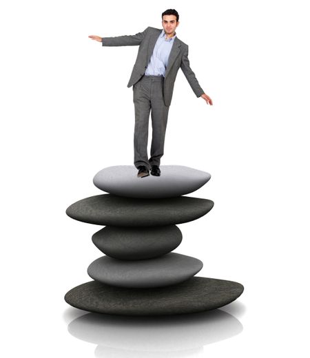 business man balancing over a pile of stones isolated