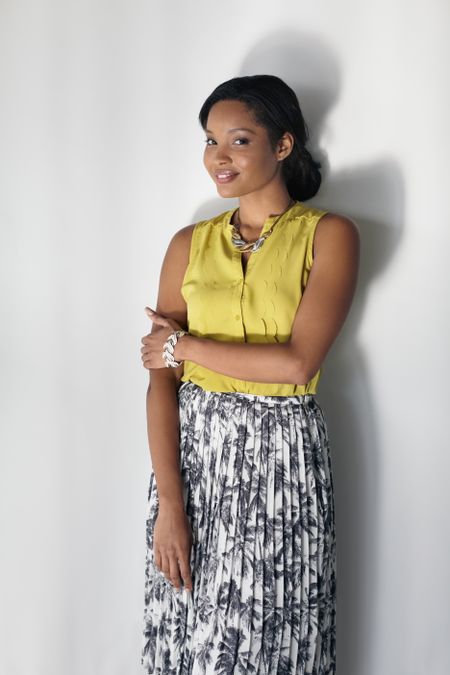 Portrait of a smiling business woman in bright glass office