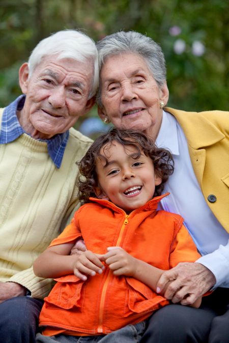 Portrait of a Kid with his grandparents outdoors