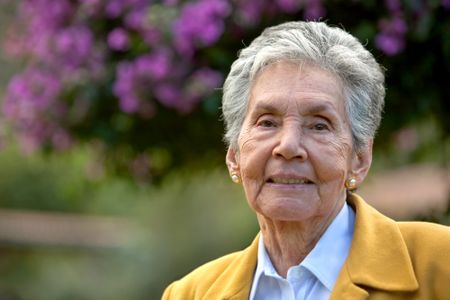  portrait of and elderly woman outdoors smiling