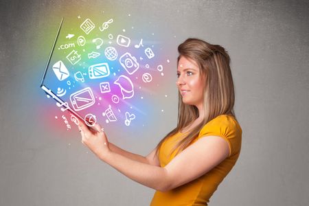 Beautiful young woman holding notebook with colorful hand drawn multimedia icons