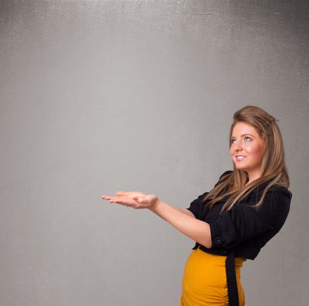 Pretty young woman presenting an empty copy space